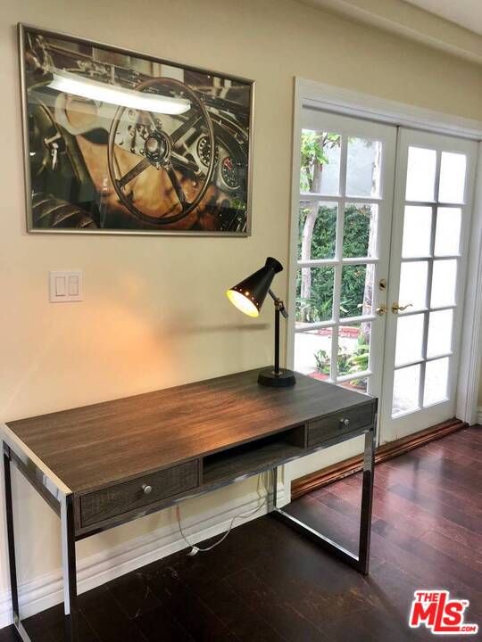 9601 Heather Road Beverly Hills, CA 90210 - Photo 13 of 21 a view of a room with rack and wooden floor