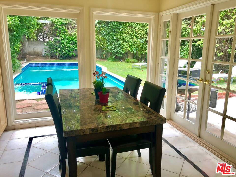 9601 Heather Road Beverly Hills, CA 90210 - Photo 2 of 21 a view of a dining room with furniture window and outside view