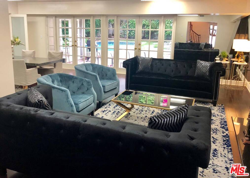 9601 Heather Road Beverly Hills, CA 90210 - Photo 4 of 21 a living room with furniture and a flat screen tv