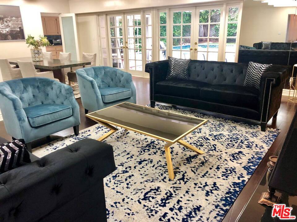 9601 Heather Road Beverly Hills, CA 90210 - Photo 5 of 21 a living room with furniture and a couch