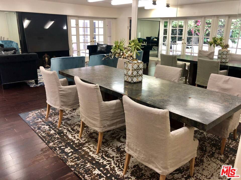 9601 Heather Road Beverly Hills, CA 90210 - Photo 6 of 21 a dining room with furniture and wooden floor