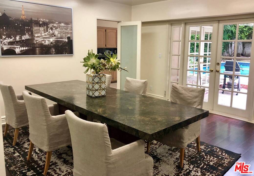 9601 Heather Road Beverly Hills, CA 90210 - Photo 7 of 21 a dining room with furniture and wooden floor
