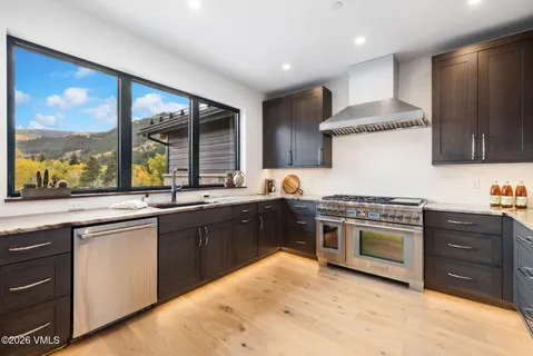 a kitchen with stainless steel appliances granite countertop a stove and a sink