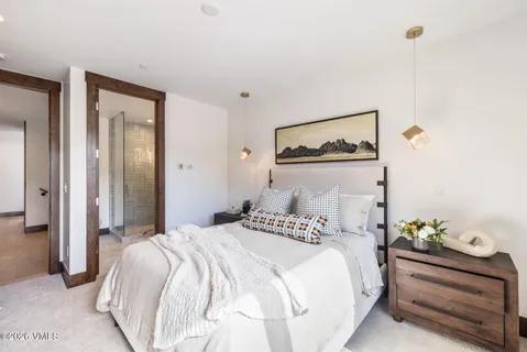 a bedroom with a bed and painting on the wall