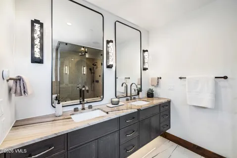 a bathroom with a double vanity sink mirror and double