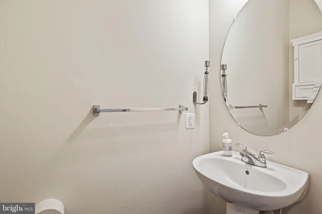 a bathroom with a sink a shower and a mirror