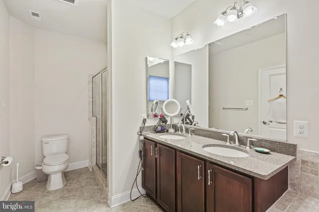 a bathroom with a sink a toilet and a mirror