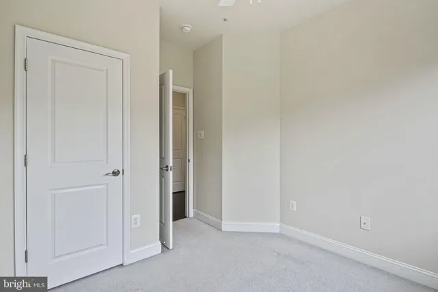 an empty room with closet area