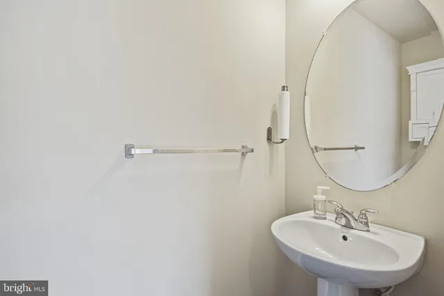 a bathroom with a sink a mirror and shower