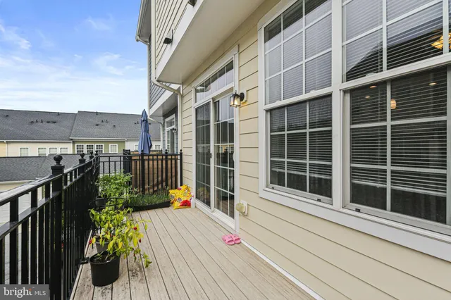a view of a balcony with chairs potted plants
