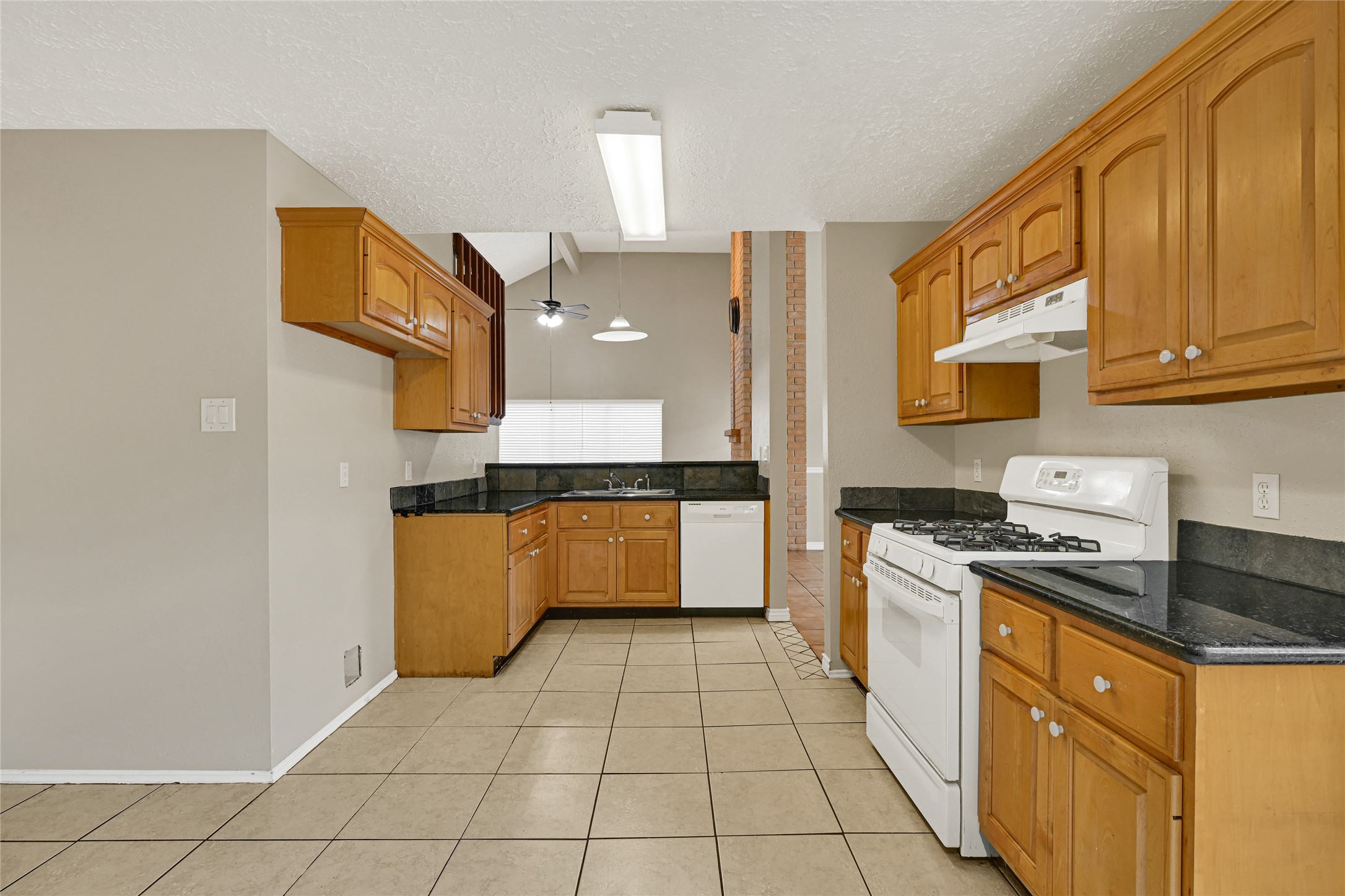 12322 Meadow Ridge Drive Stafford, TX 77477 - Photo 11 of 39 a kitchen with stainless steel appliances granite countertop a stove a sink and a refrigerator