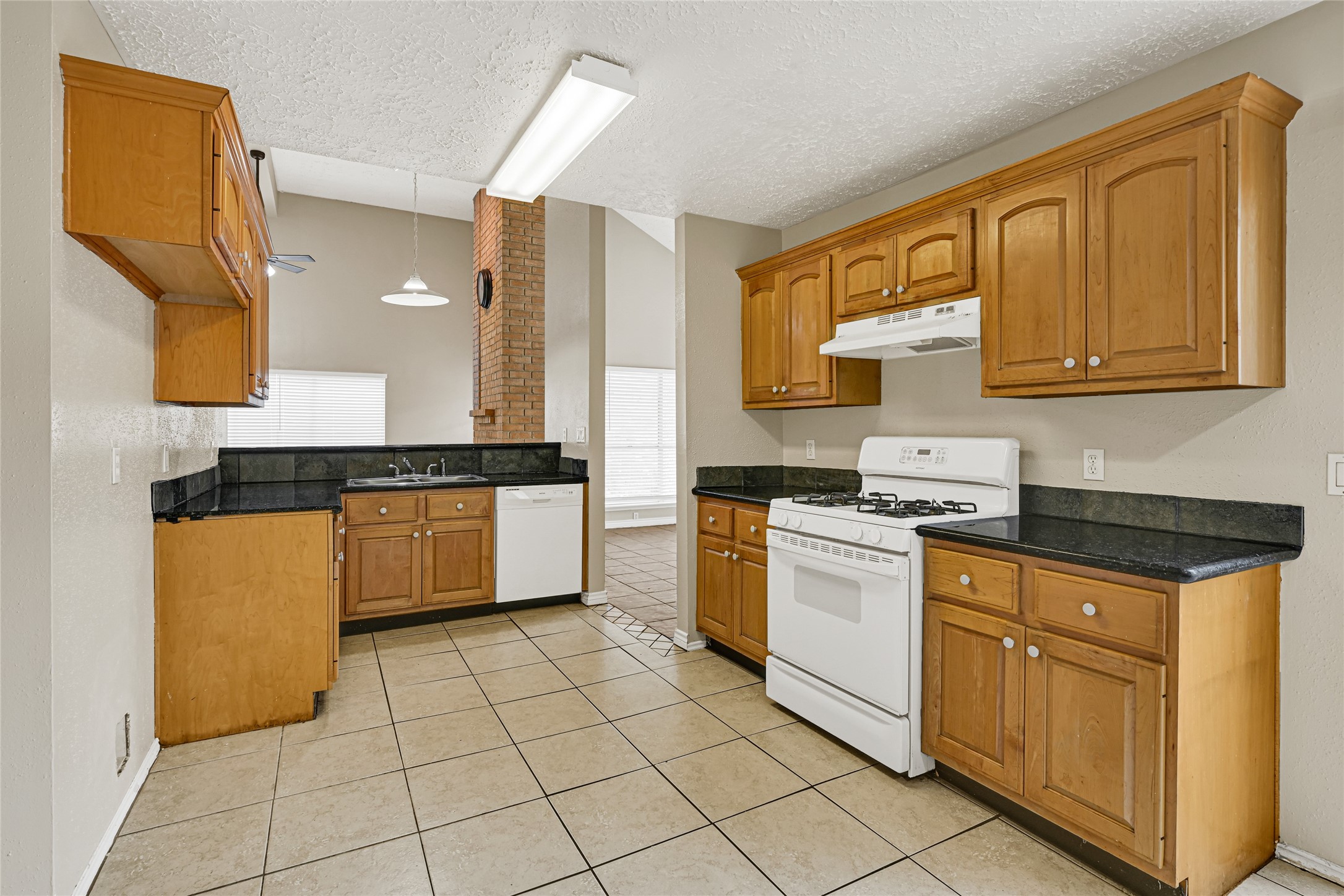 12322 Meadow Ridge Drive Stafford, TX 77477 - Photo 12 of 39 a kitchen with stainless steel appliances granite countertop a stove a sink and a refrigerator