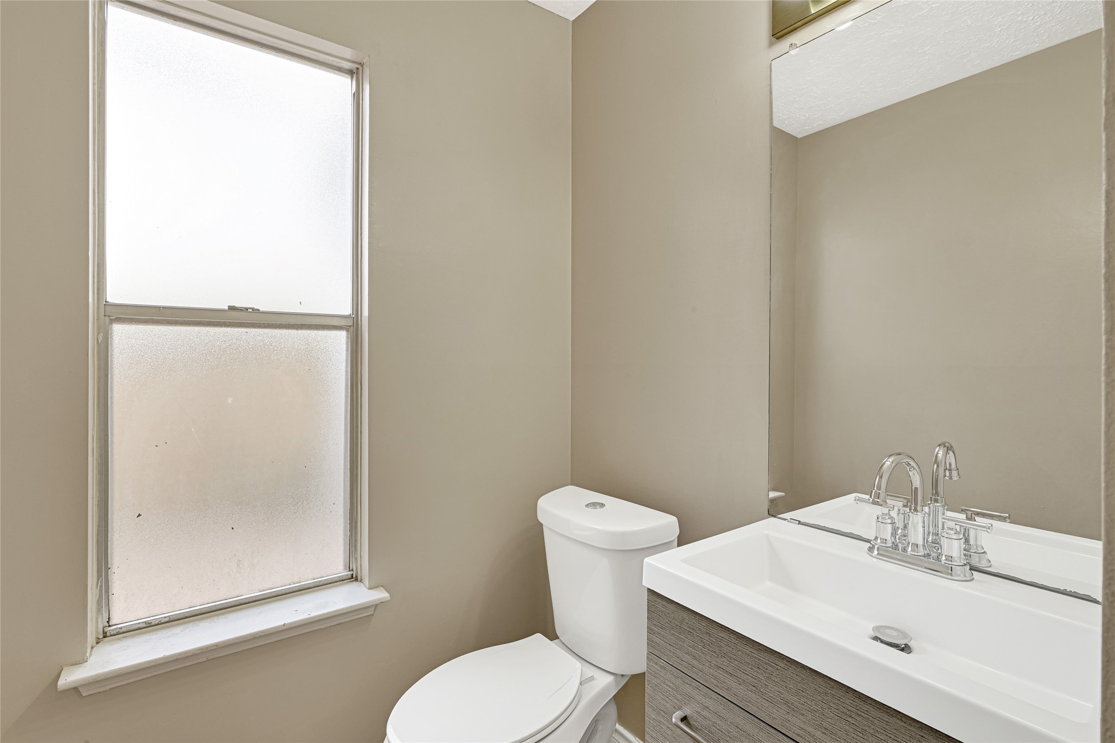 12322 Meadow Ridge Drive Stafford, TX 77477 - Photo 15 of 39 a white toilet sitting next to a bathroom sink
