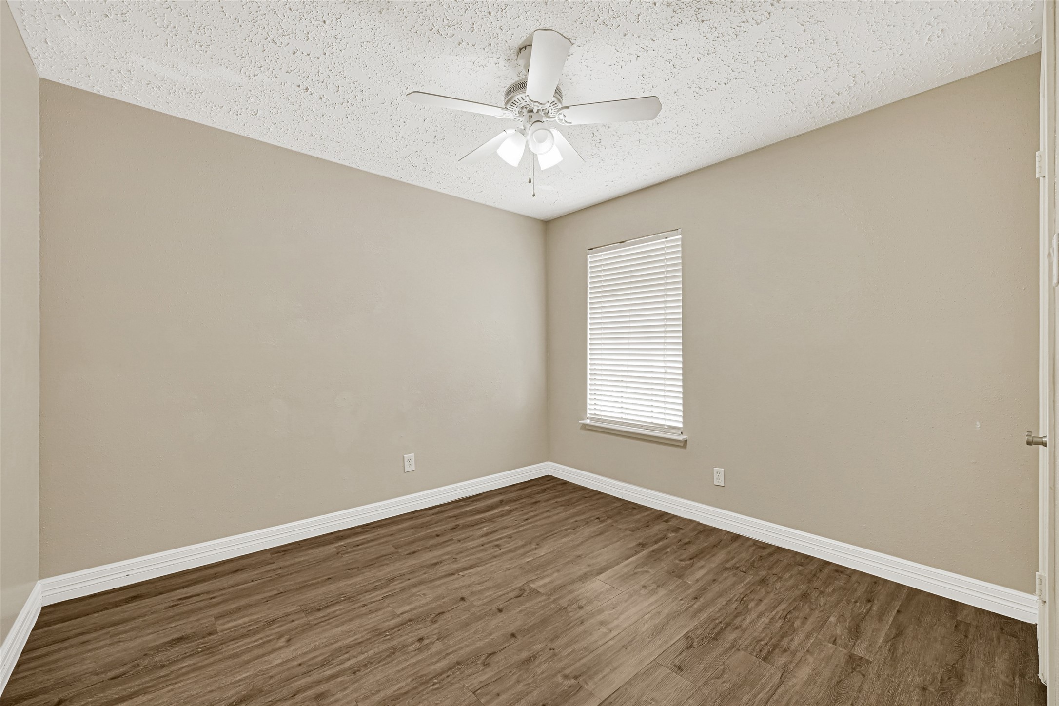 12322 Meadow Ridge Drive Stafford, TX 77477 - Photo 26 of 39 wooden floor in an empty room with a window