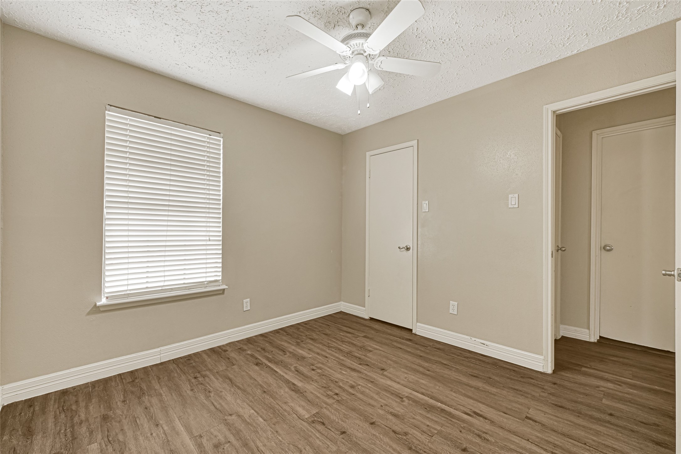 12322 Meadow Ridge Drive Stafford, TX 77477 - Photo 27 of 39 an empty room with wooden floor and windows