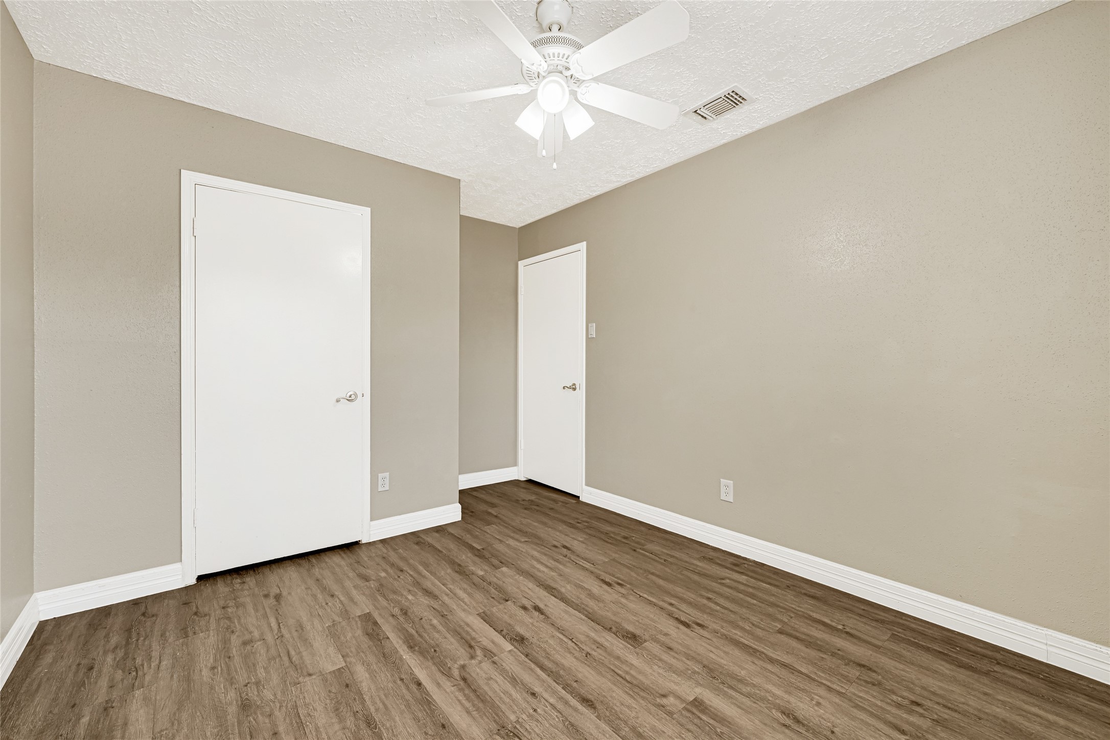 12322 Meadow Ridge Drive Stafford, TX 77477 - Photo 29 of 39 an empty room with wooden floor and a ceiling fan