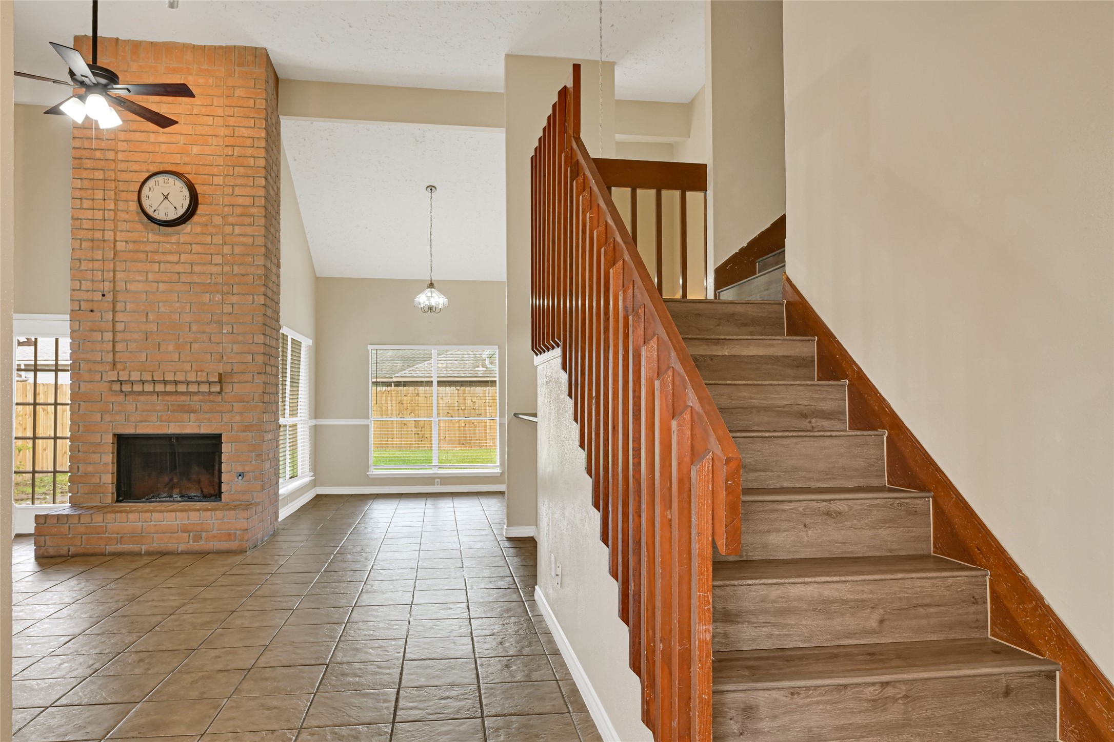 12322 Meadow Ridge Drive Stafford, TX 77477 - Photo 4 of 39 a view of a hallway with wooden floor and a fireplace