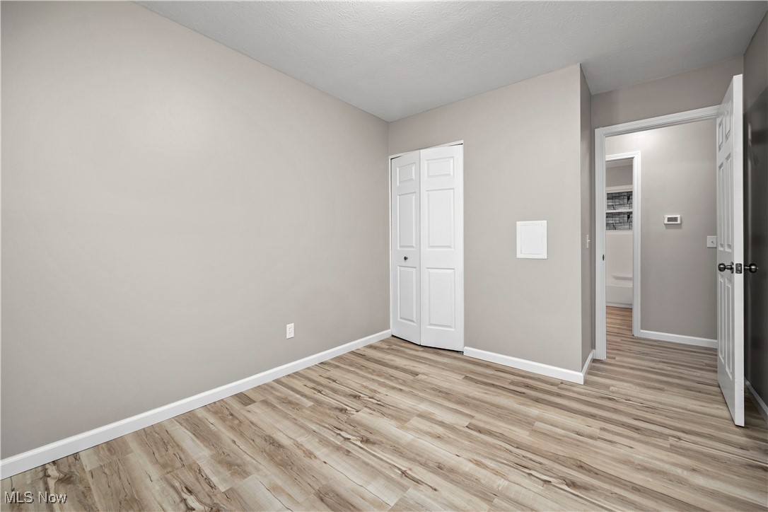 6265 Jaycox Road North Ridgeville, OH 44039 - Photo 29 of 39 Unfurnished bedroom with baseboards, light wood-style floors, and a closet