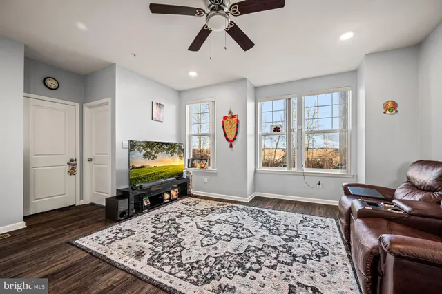 a living room with a couch a rug and a flat screen tv
