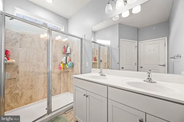a bathroom with a sink double vanity and a shower