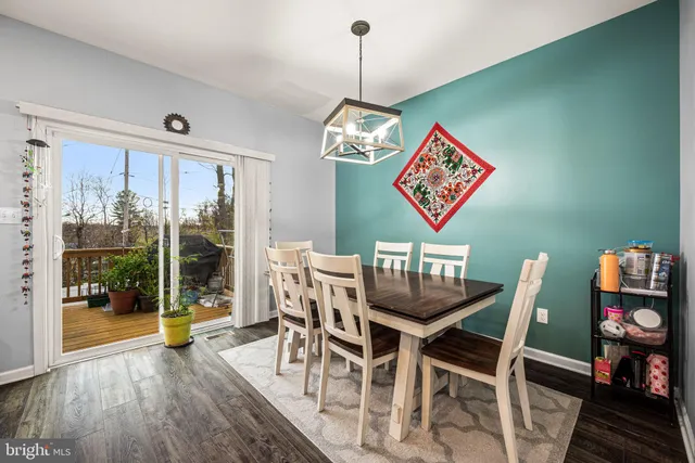 a view of a dining room with furniture wooden floor and front door