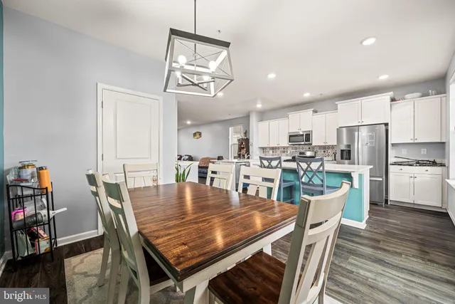 a dining room with kitchen island a table and chairs