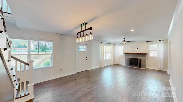 a view of entryway and hall with wooden floor