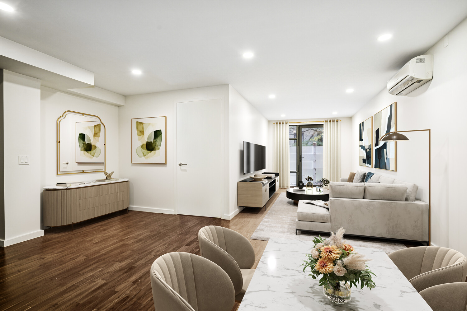 a living room with furniture and a wooden floor