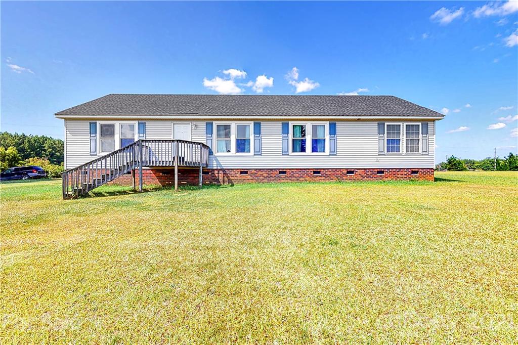 4407 Wolf Pond Road Monroe, NC 28112 - Photo 1 of 26 a front view of a house with swimming pool having outdoor seating