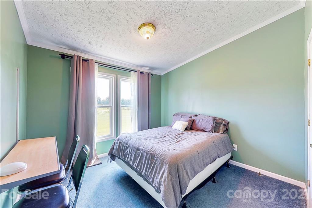 4407 Wolf Pond Road Monroe, NC 28112 - Photo 16 of 26 a bedroom with a bed and window