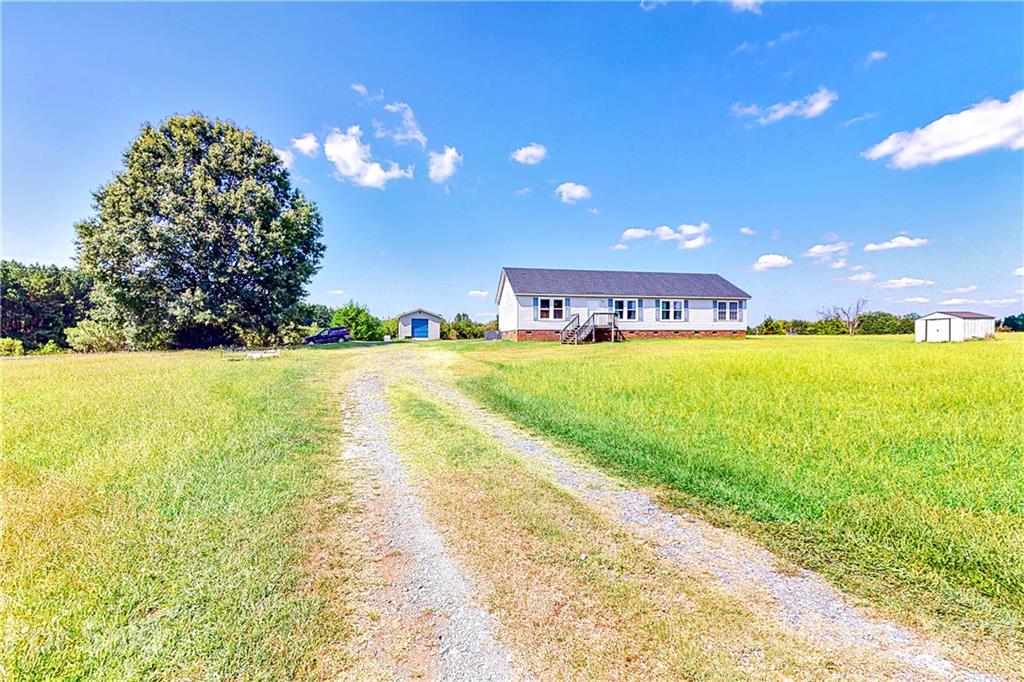 4407 Wolf Pond Road Monroe, NC 28112 - Photo 3 of 26 a view of a lake with a big yard