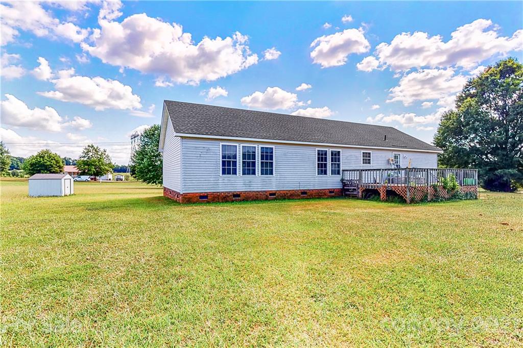 4407 Wolf Pond Road Monroe, NC 28112 - Photo 24 of 26 a view of a house with a backyard