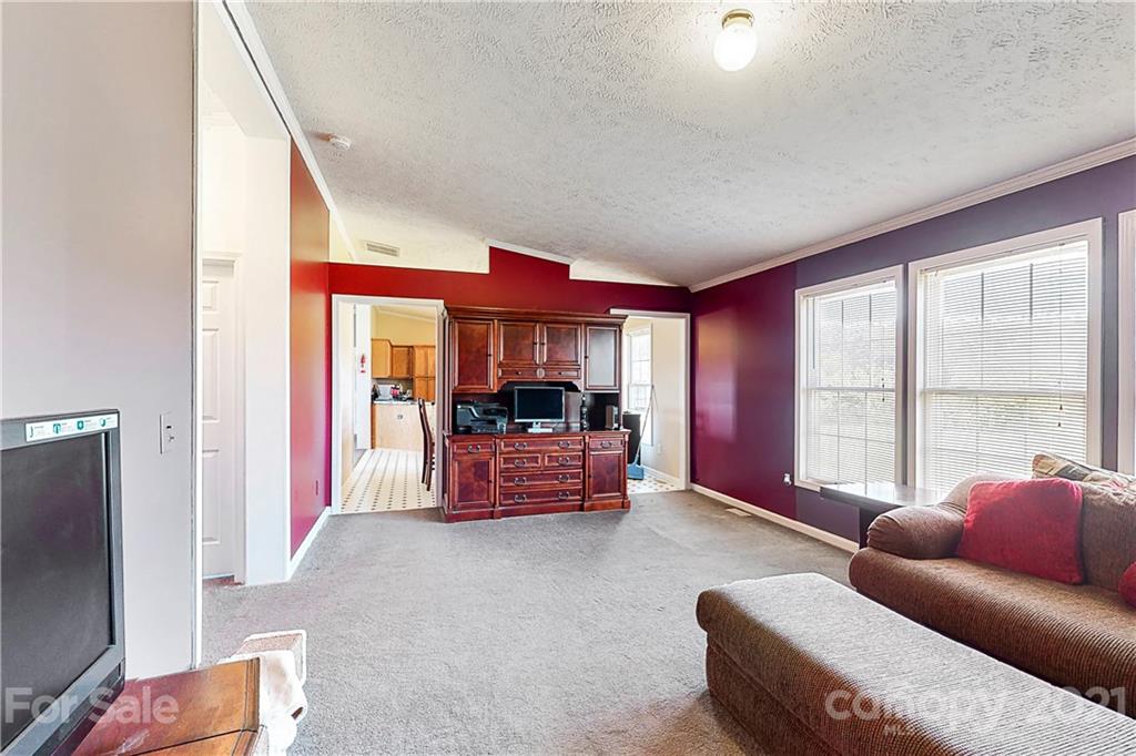 4407 Wolf Pond Road Monroe, NC 28112 - Photo 6 of 26 a living room with furniture and a flat screen tv