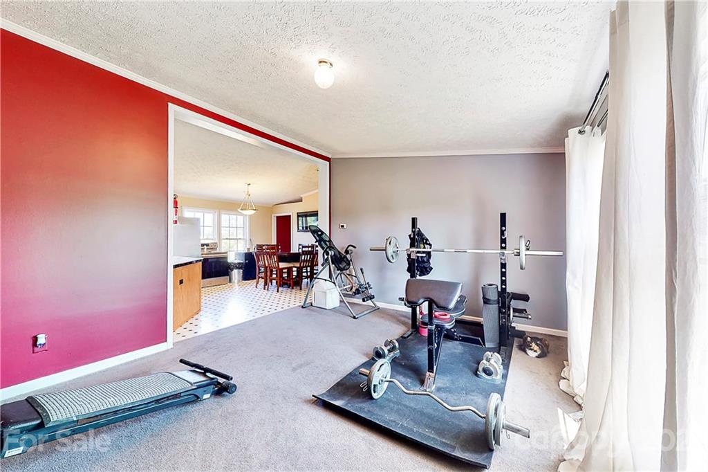 4407 Wolf Pond Road Monroe, NC 28112 - Photo 7 of 26 a room with gym equipment and a mirror