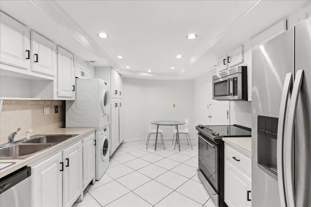 a kitchen with stainless steel appliances a refrigerator sink and microwave