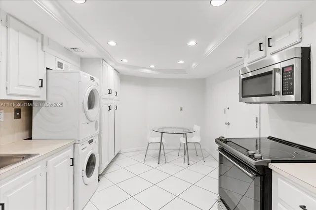 a kitchen with a sink appliances and cabinets
