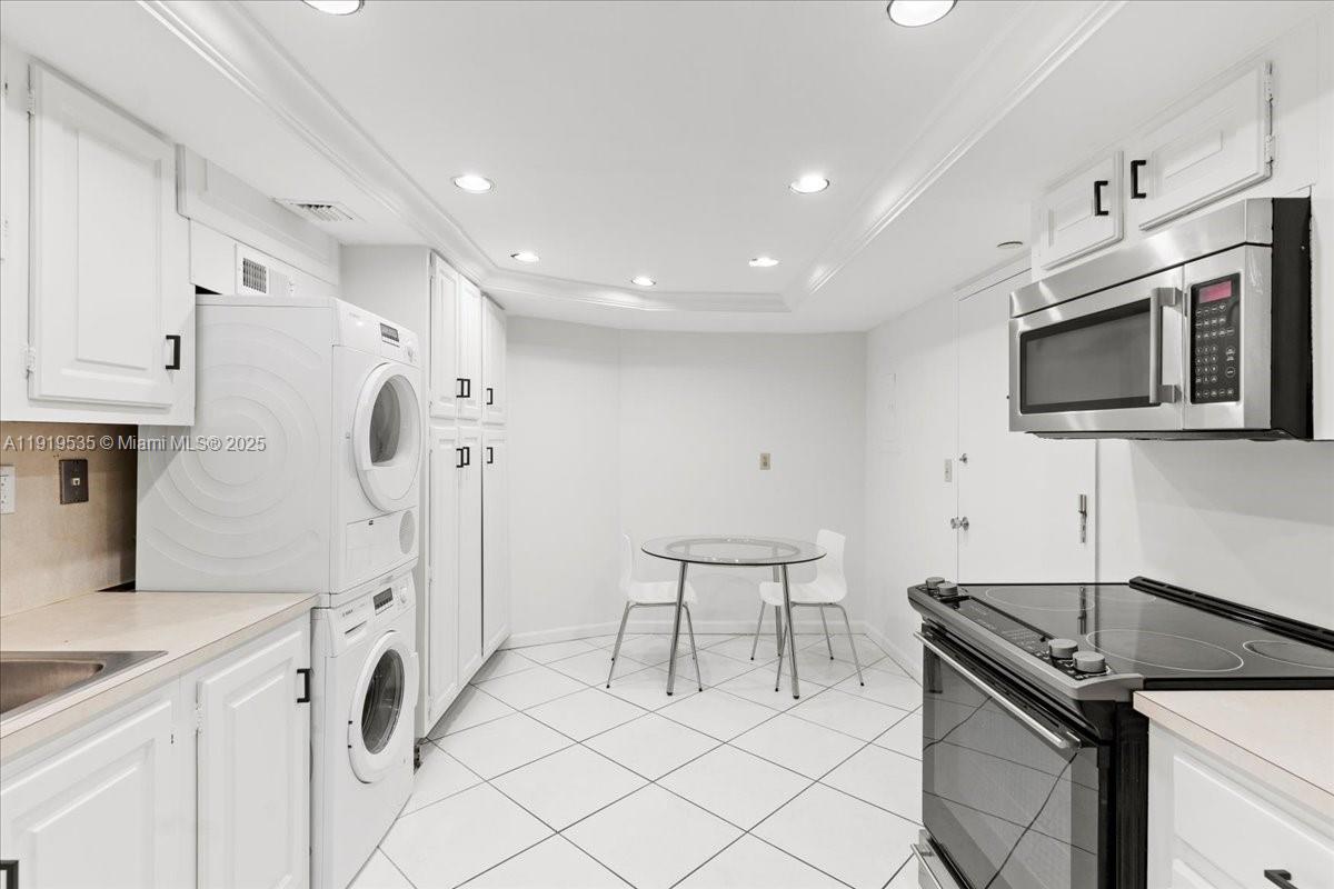 1121 Crandon Boulevard, Unit E304 Key Biscayne, FL 33149 - Photo 5 of 17 a kitchen with a sink appliances and cabinets