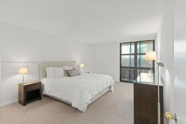 a bedroom with a bed and a lamp