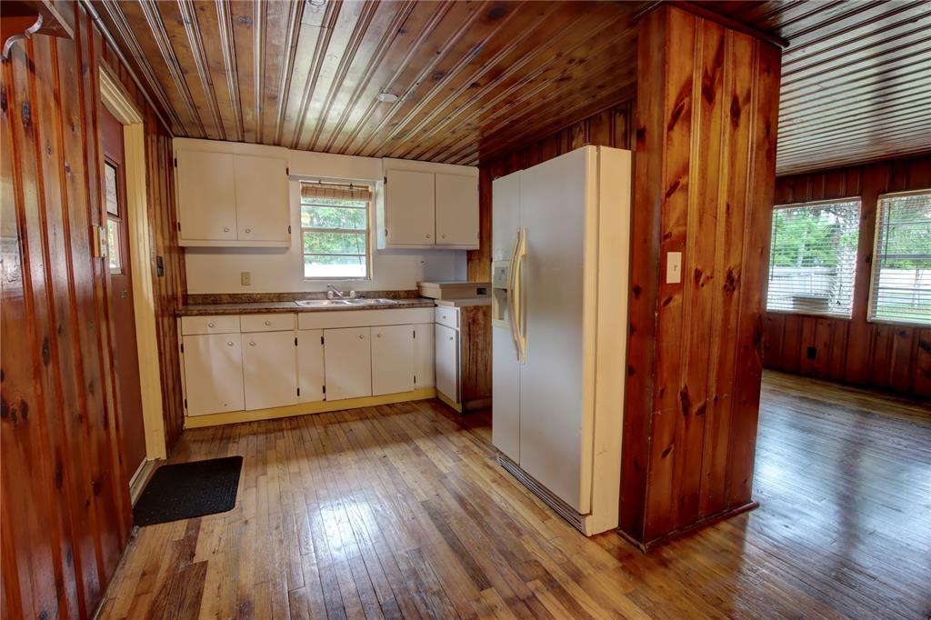 1870 Lake Markham Road Sanford, FL 32771 - Photo 14 of 23 a kitchen with stainless steel appliances granite countertop a refrigerator a sink dishwasher a stove and white countertops with wooden floor