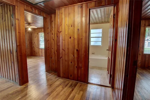 a view of a hallway with wooden floor