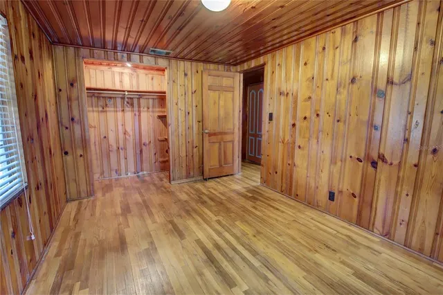 a view of a hallway with wooden walls