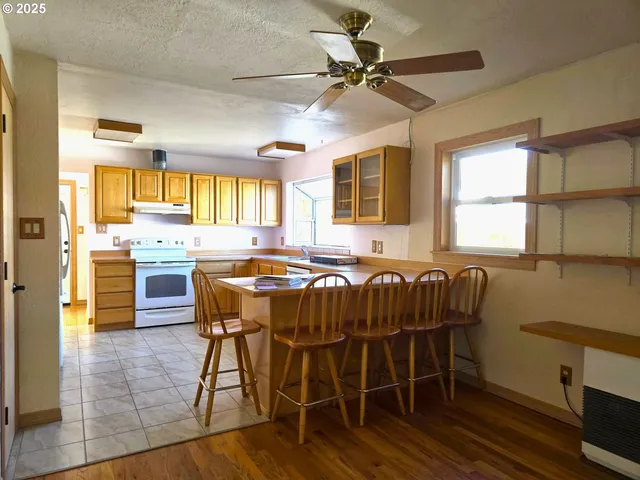 a kitchen with a table chairs sink and cabinets