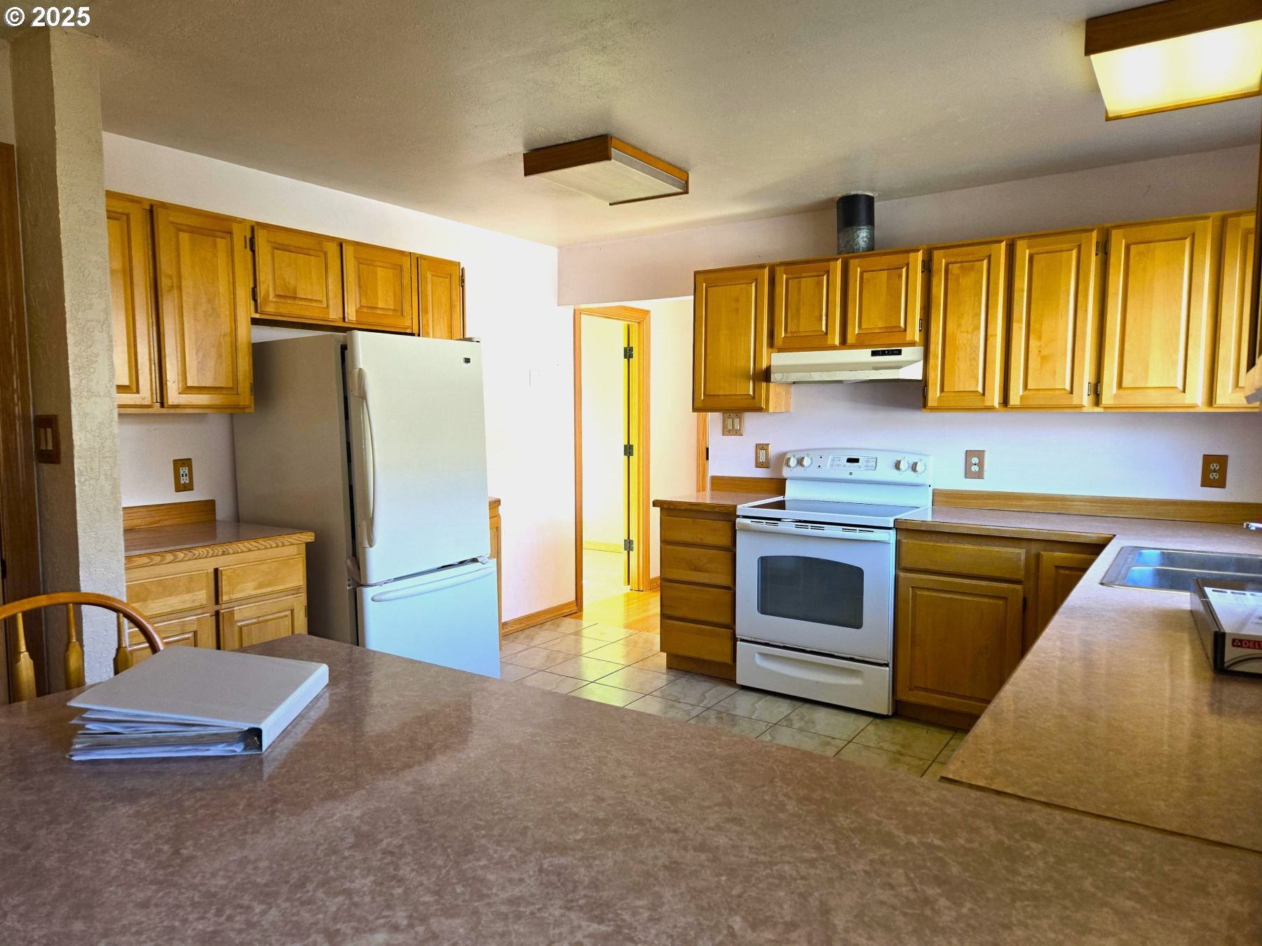 212 Northwest 5th Avenue John Day, OR 97845 - Photo 14 of 38 a kitchen with stainless steel appliances a stove a refrigerator and a sink