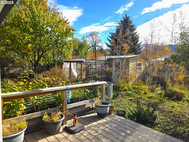 a view of a balcony with wooden floor and outdoor seating