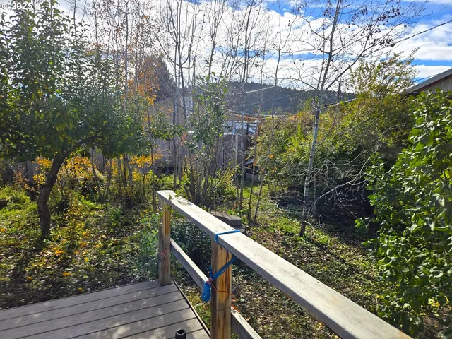 a view of balcony with wooden floor and fence