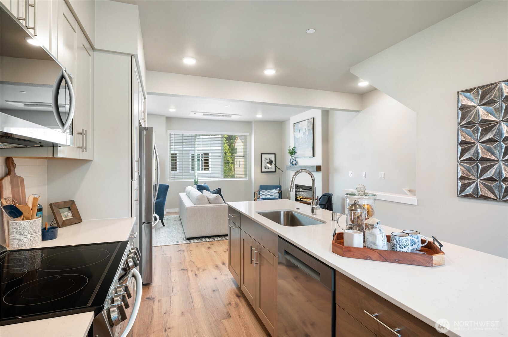1322 194th Street Southeast, Unit B3 Bothell, WA 98012 - Photo 7 of 13 a kitchen with stainless steel appliances a sink stove and cabinets