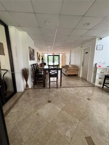 a view of a livingroom with furniture and a window