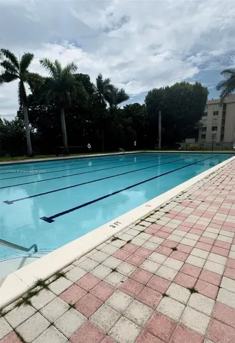 a view of backyard and wooden fence
