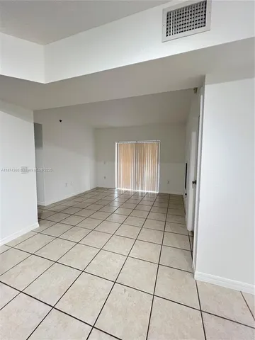 a view of a livingroom with an empty space and a window