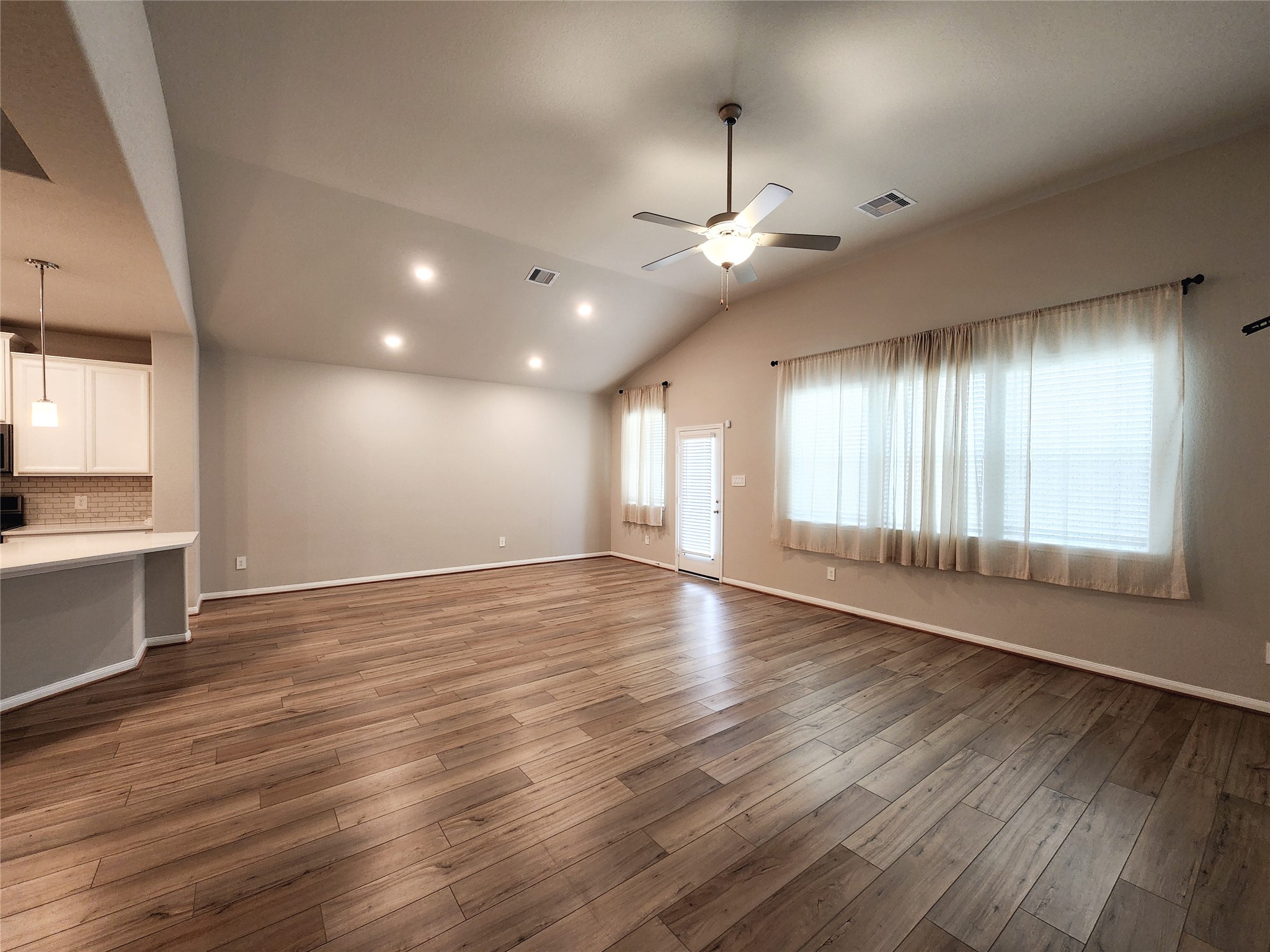 10714 Clfs Vw Drive Rosharon, TX 77583 - Photo 22 of 30 an empty room with wooden floor and windows